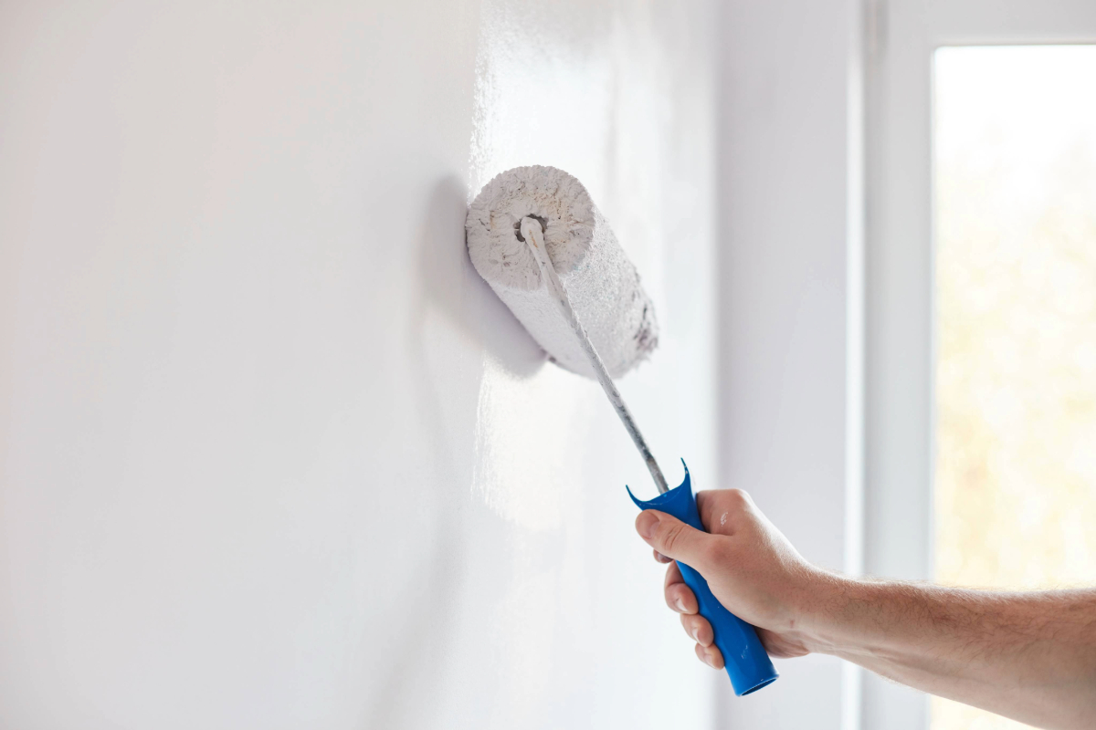 hand painting wall with paint roller